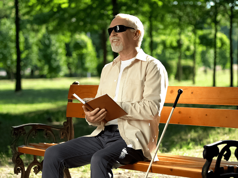 LBPH Resource; Image of blind man reading a book in braille.