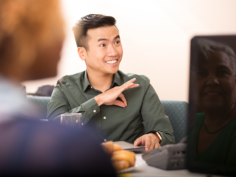 Interpreting resources; photo of an Asian Man interpreting in ASL
